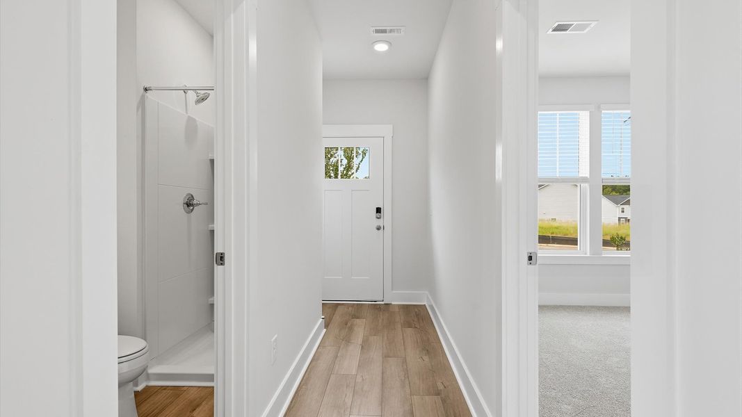 Superior design begins at the front door with a hardwood floor foyer and elegant sightlines at Clarke Townes