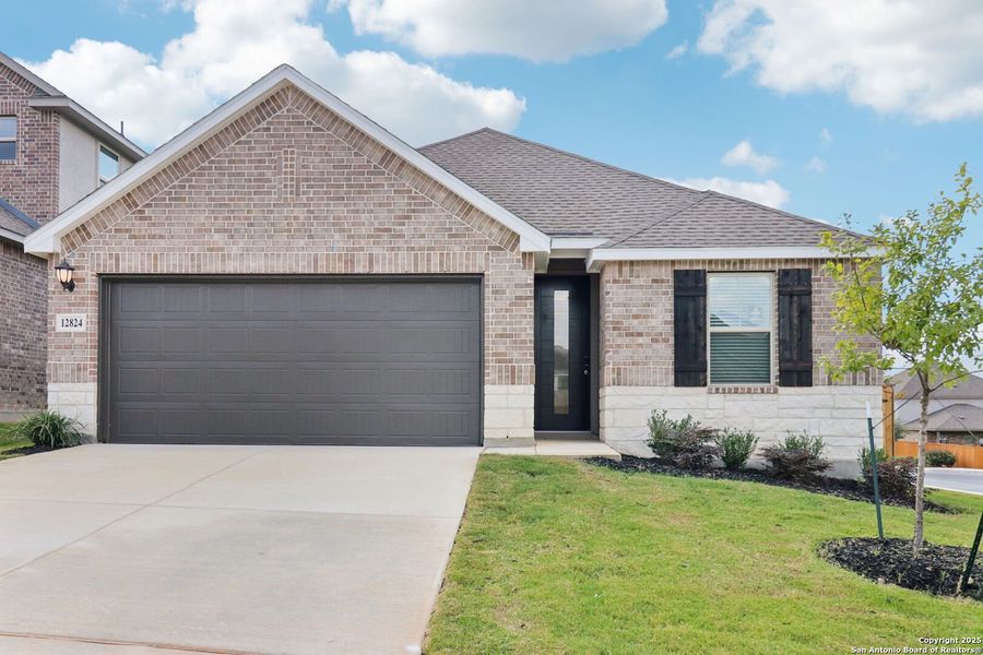 Front exterior of a new home in Arcadia Ridge - Premier Series, San Antonio, TX, highlighting curb appeal (Image 20).