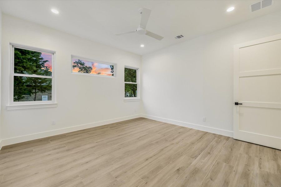 Spare room featuring light wood-style floors, ceiling fan, and recessed lighting