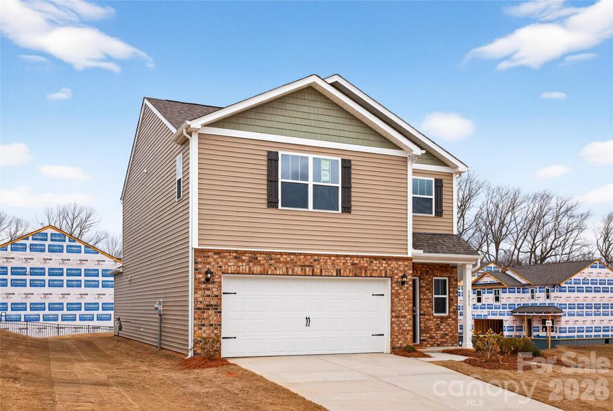 Front exterior of a new home in Reedy Creek Preserve, Charlotte, NC, highlighting curb appeal (Image 25).