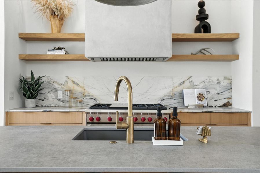 Kitchen with open shelves, tasteful backsplash, and light countertops Kitchen with open shelves, tasteful backsplash, and light countertops