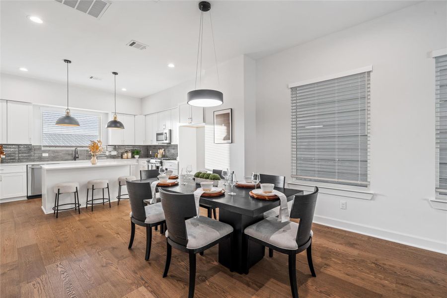 The dining area opens seamlessly to the kitchen, giving you plenty of space to host large gatherings while still staying connected with your guests.
