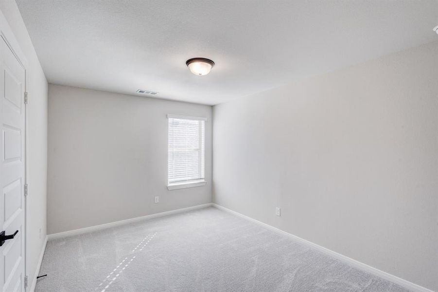 Spare room featuring carpet flooring