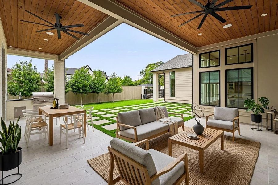 Designed for year-round outdoor living, the covered patio offers a spacious setting w/ a wood plank ceiling, recessed lighting, ceiling fans & integrated speakers. Seamlessly connected to the interior living spaces, it creates an ideal environment for both relaxing & entertaining. Designed for year-round outdoor living, the covered patio offers a spacious setting w/ a wood plank ceiling, recessed lighting, ceiling fans & integrated speakers. Seamlessly connected to the interior living spaces, it creates an ideal environment for both relaxing & entertaining.