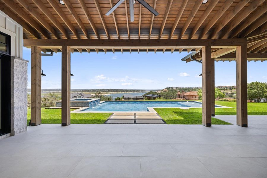 View of patio with a pool with connected hot tub and ceiling fan