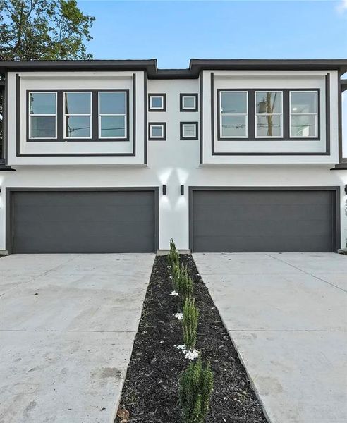 View of front of property with driveway, an attached garage, and stucco siding View of front of property with driveway, an attached garage, and stucco siding