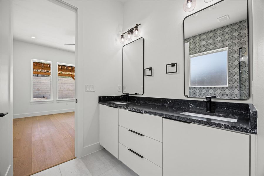 Bathroom featuring double vanity, light tile patterned floors, and recessed lighting Bathroom featuring double vanity, light tile patterned floors, and recessed lighting
