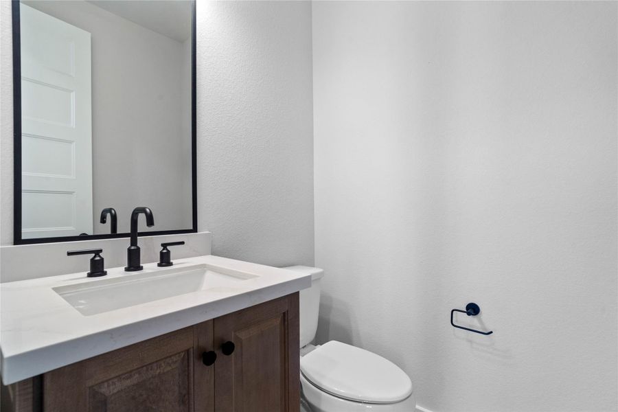 The powder bath features a stylish vanity and a clean, modern design.