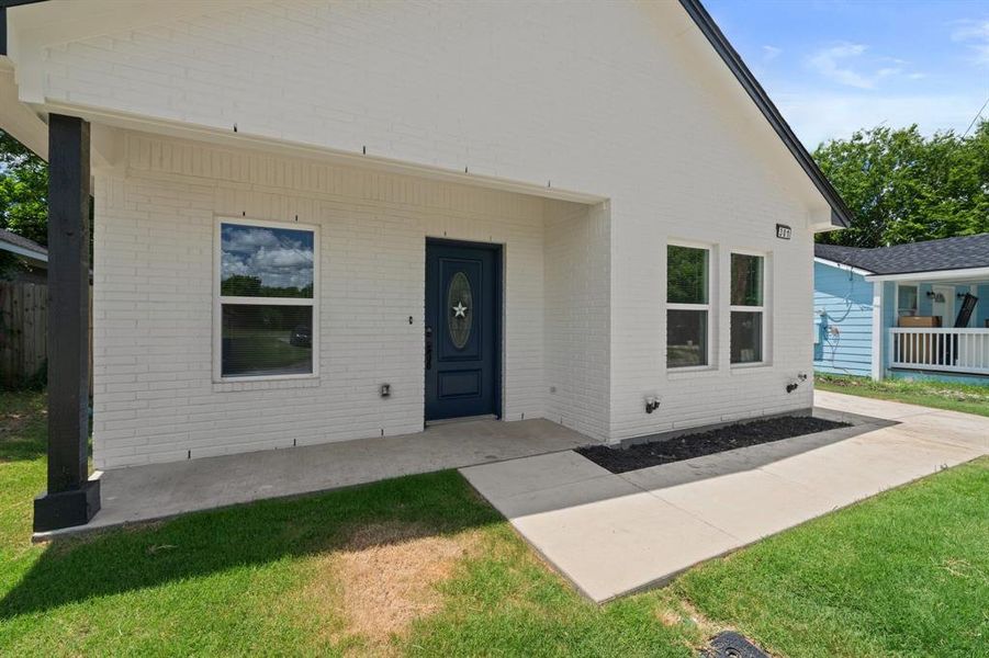 View of front of house with brick siding and a front yard View of front of house with brick siding and a front yard