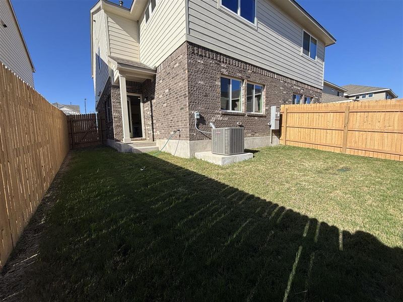 Exterior space with a yard and central AC