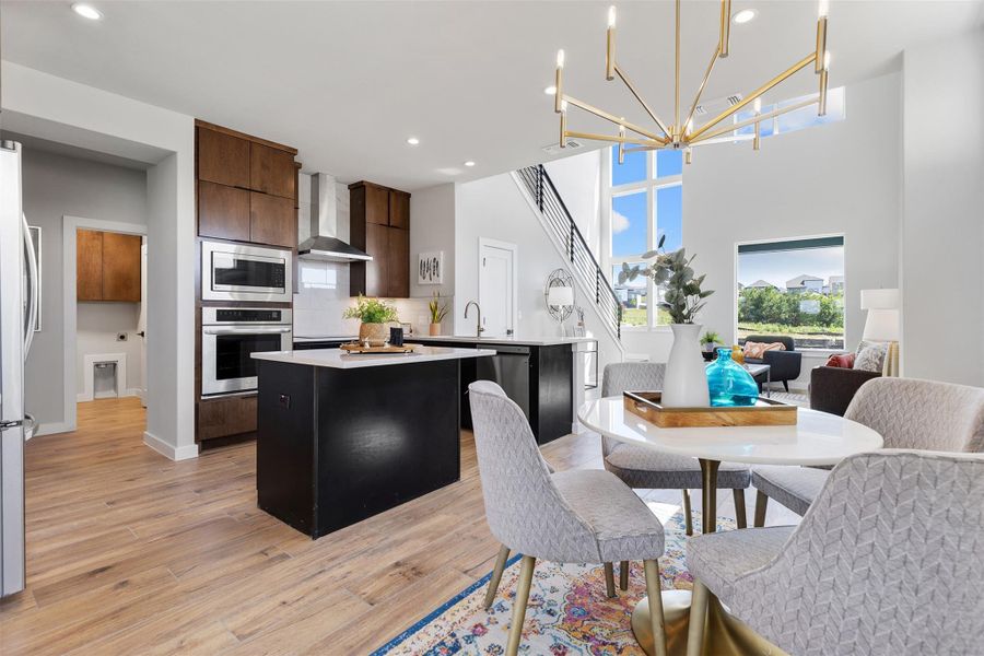 Kitchen with a center island, a chandelier, stainless steel appliances, tasteful backsplash, and recessed lighting