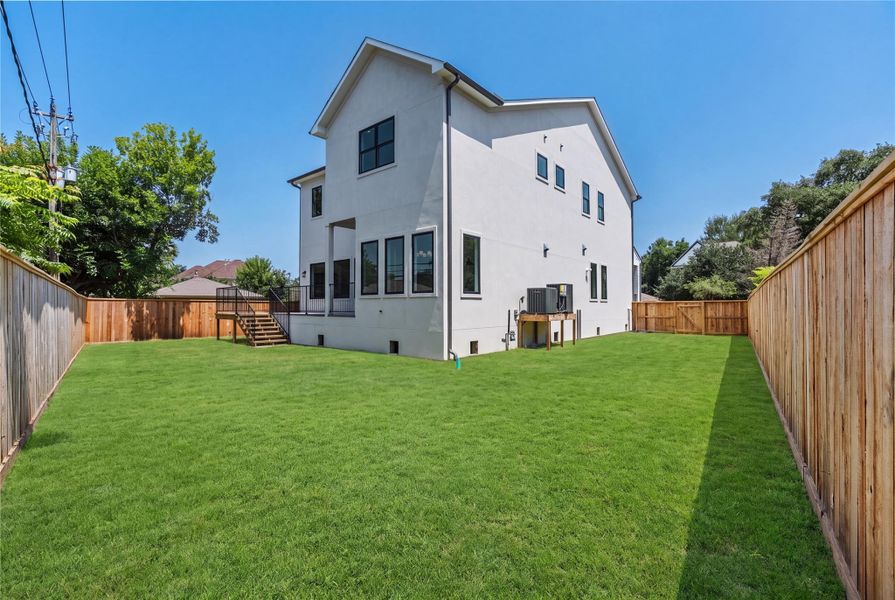 Expansive backyard with ample green space for a pool or future outdoor amenities.