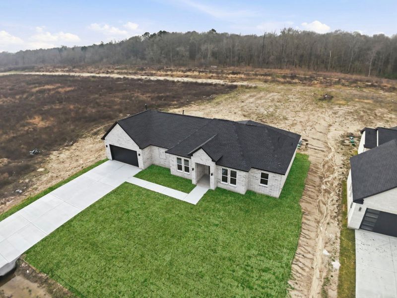 Front exterior of a new home in , Dayton, TX, highlighting curb appeal (Image 28).