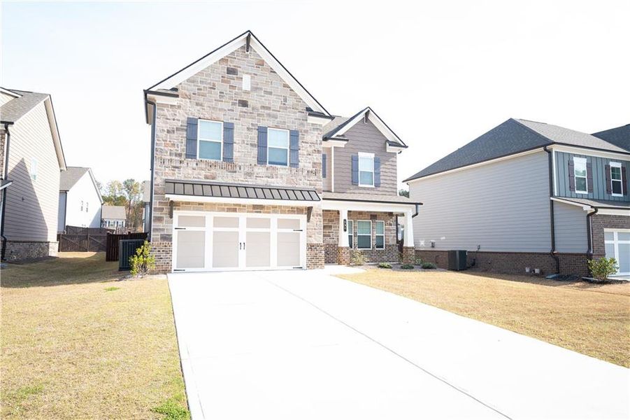 Front exterior of a new home in Canterbury Reserve, Lawrenceville, GA, highlighting curb appeal (Image 19).