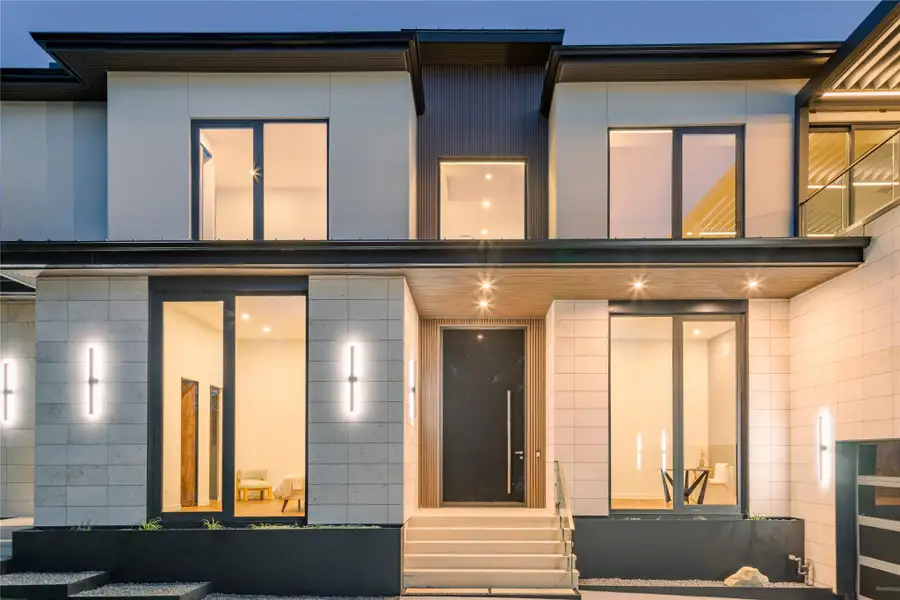 Modern architecture with expansive windows illuminates this sophisticated façade, featuring clean lines and a grand entrance.