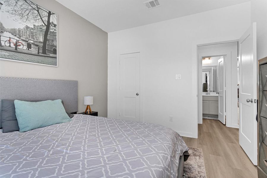 This alternate view highlights the first-floor secondary bedroom with convenient access to a full bathroom, making it ideal for guests or extended stays.