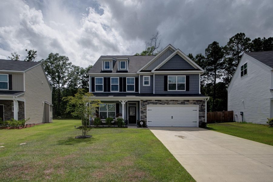 Front exterior of a new home in Oakley Pointe, Moncks Corner, SC, highlighting curb appeal (Image 24). Front exterior of a new home in Oakley Pointe, Moncks Corner, SC, highlighting curb appeal (Image 24).