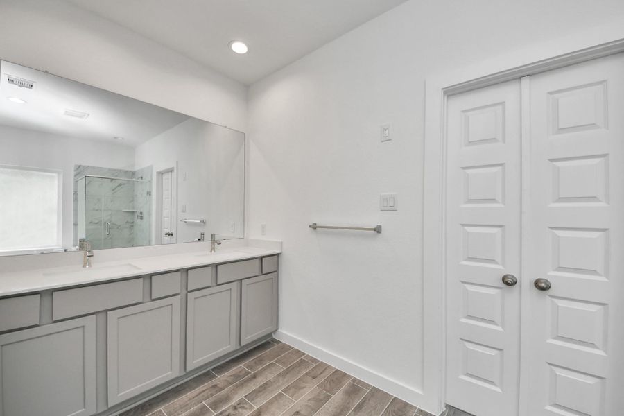 Elevate your daily routine at the elegant vanity, now equipped with double sinks, light countertops, modern hardware, and beautiful recessed lights. Elevate your daily routine at the elegant vanity, now equipped with double sinks, light countertops, modern hardware, and beautiful recessed lights.