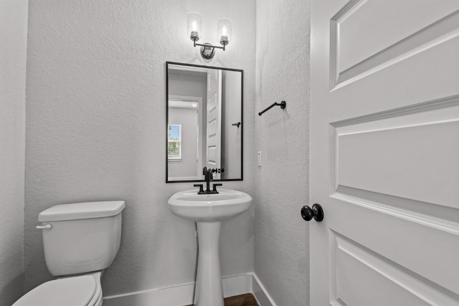 A bathroom with a sink and toilet.