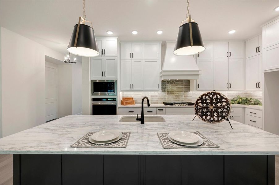 Another close up view of this beautiful Kitchen.  Undercabinet lighting, quartz counters and lots of storage!