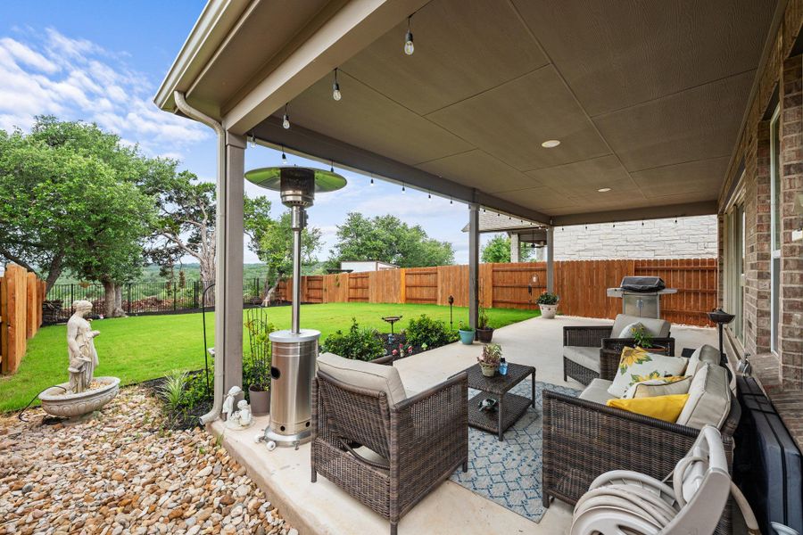 An inviting covered patio offers a comfortable outdoor living space with expansive views of the fenced backyard. An inviting covered patio offers a comfortable outdoor living space with expansive views of the fenced backyard.