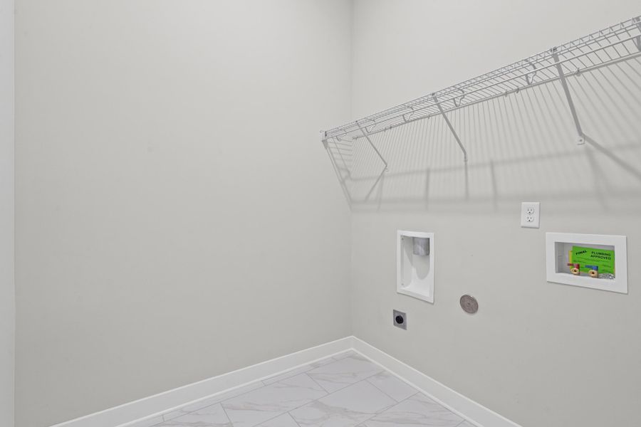 Laundry room featuring light marble finish floors, hookup for an electric dryer, and washer hookup
