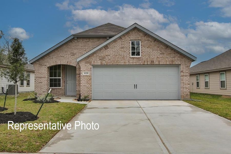 View of front of property with a garage, central AC unit, and a front lawn