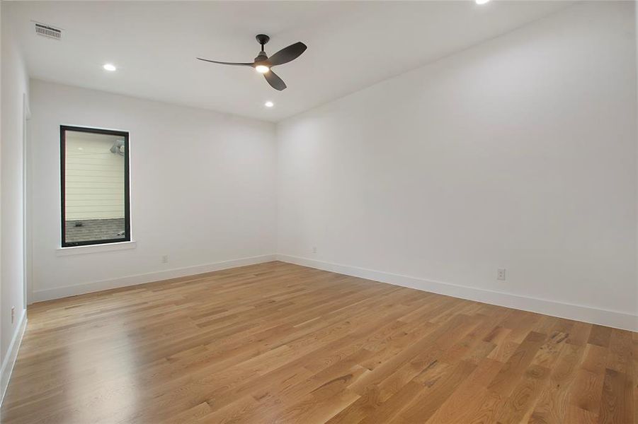 Unfurnished room with light hardwood / wood-style floors and ceiling fan