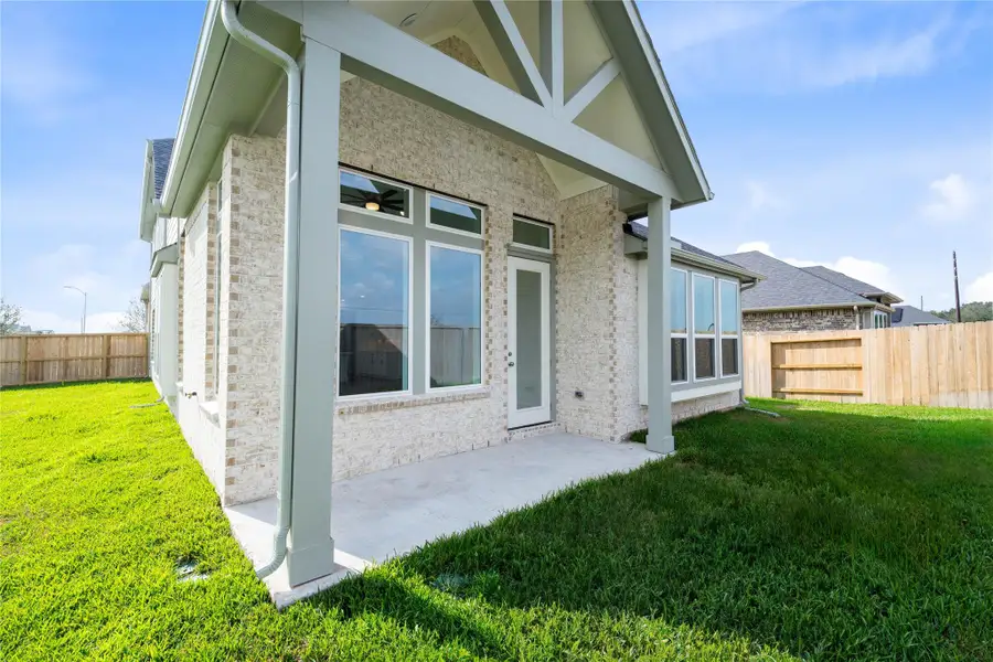 Step outside to the covered rear patio, the perfect extension of your indoor living space for year-round enjoyment.