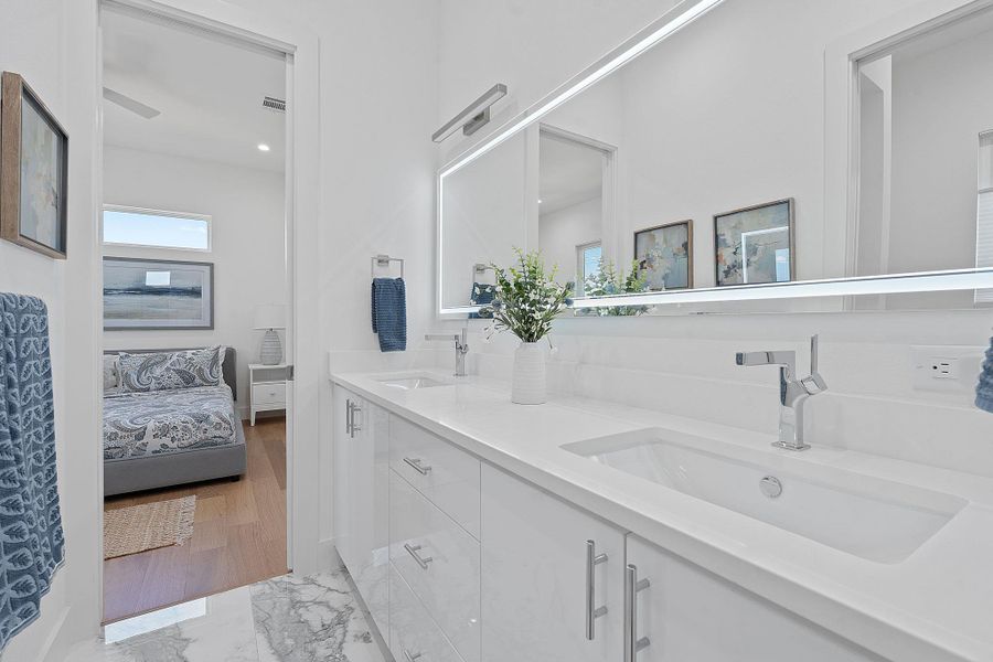 Crisp and modern secondary bath with clean finishes, generous counter space, and bright natural light. Crisp and modern secondary bath with clean finishes, generous counter space, and bright natural light.