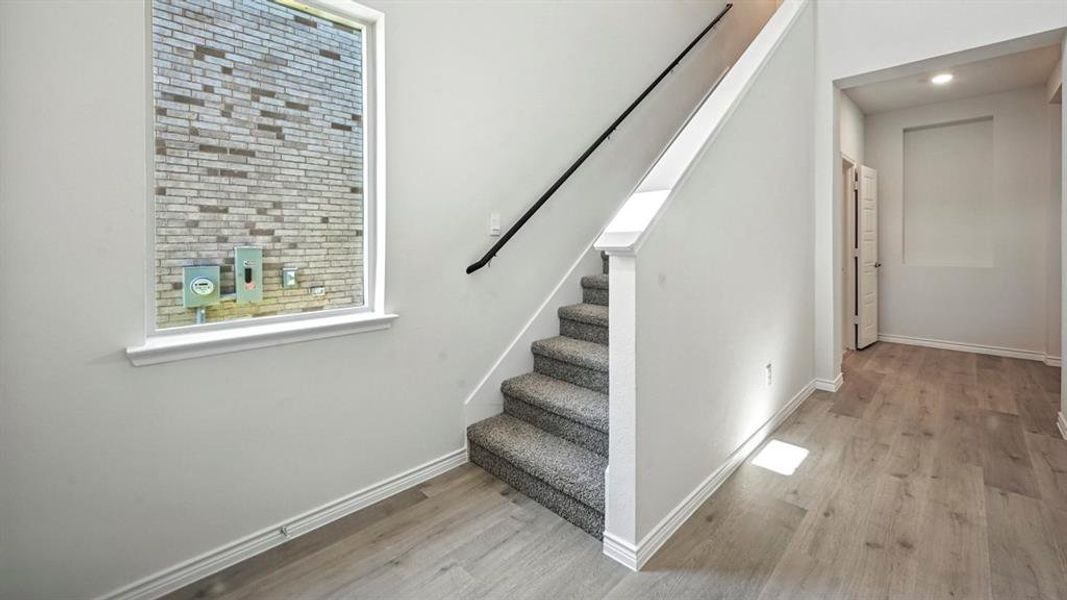 Stairway featuring baseboards and wood finished floors Stairway featuring baseboards and wood finished floors