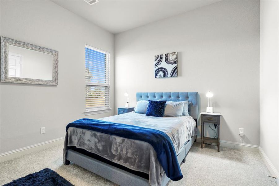 Carpeted bedroom with baseboards Carpeted bedroom with baseboards