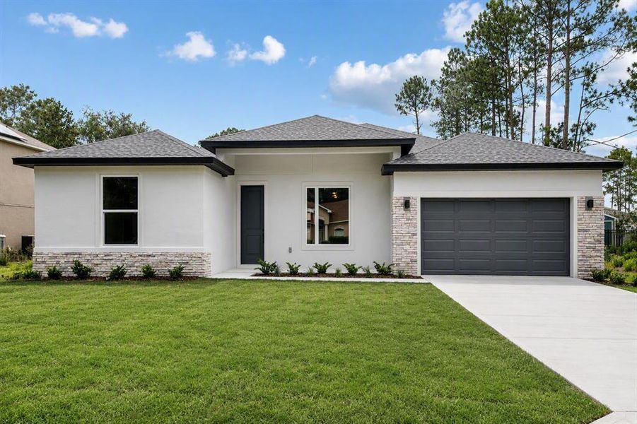 Front exterior of a new home in Palm Coast, Palm Coast, FL, highlighting curb appeal (Image 2). Front exterior of a new home in Palm Coast, Palm Coast, FL, highlighting curb appeal (Image 2).
