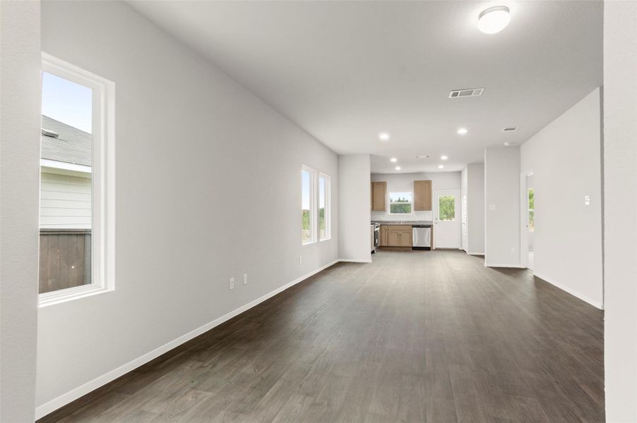 Unfurnished living room with recessed lighting and dark wood-type flooring