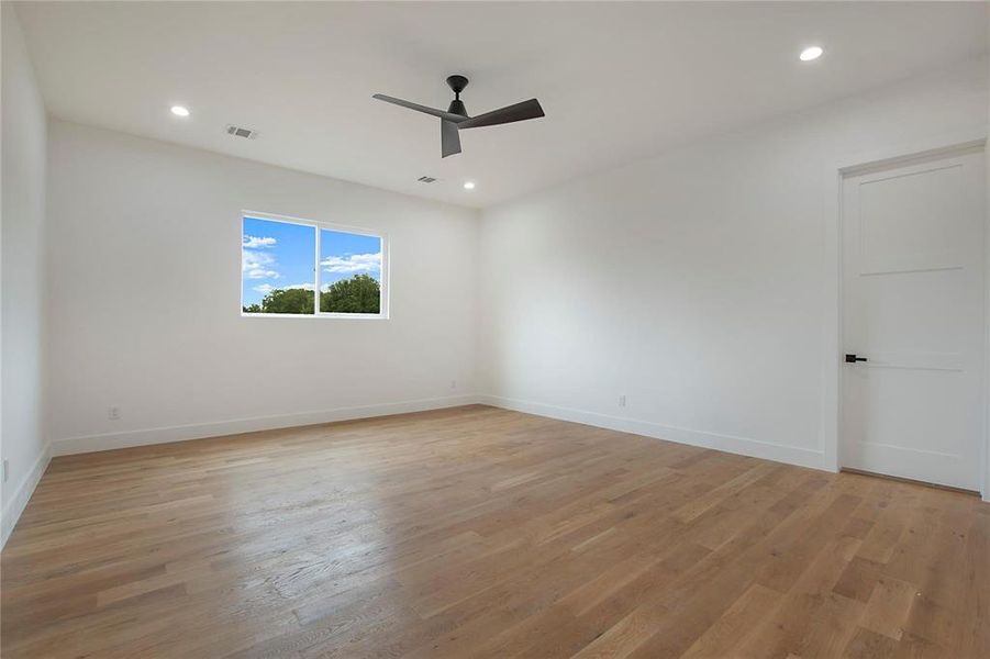 Spare room featuring a ceiling fan, light wood-type flooring, baseboards, and recessed lighting Spare room featuring a ceiling fan, light wood-type flooring, baseboards, and recessed lighting