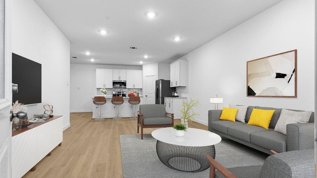 A well-organized living room that includes a kitchen and dining area, creating a warm and welcoming environment for gatherings. A well-organized living room that includes a kitchen and dining area, creating a warm and welcoming environment for gatherings.
