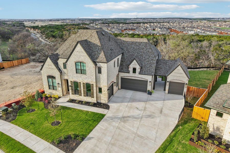 Front exterior of a new home in Palmera Ridge, Leander, TX, highlighting curb appeal (Image 2). Front exterior of a new home in Palmera Ridge, Leander, TX, highlighting curb appeal (Image 2).