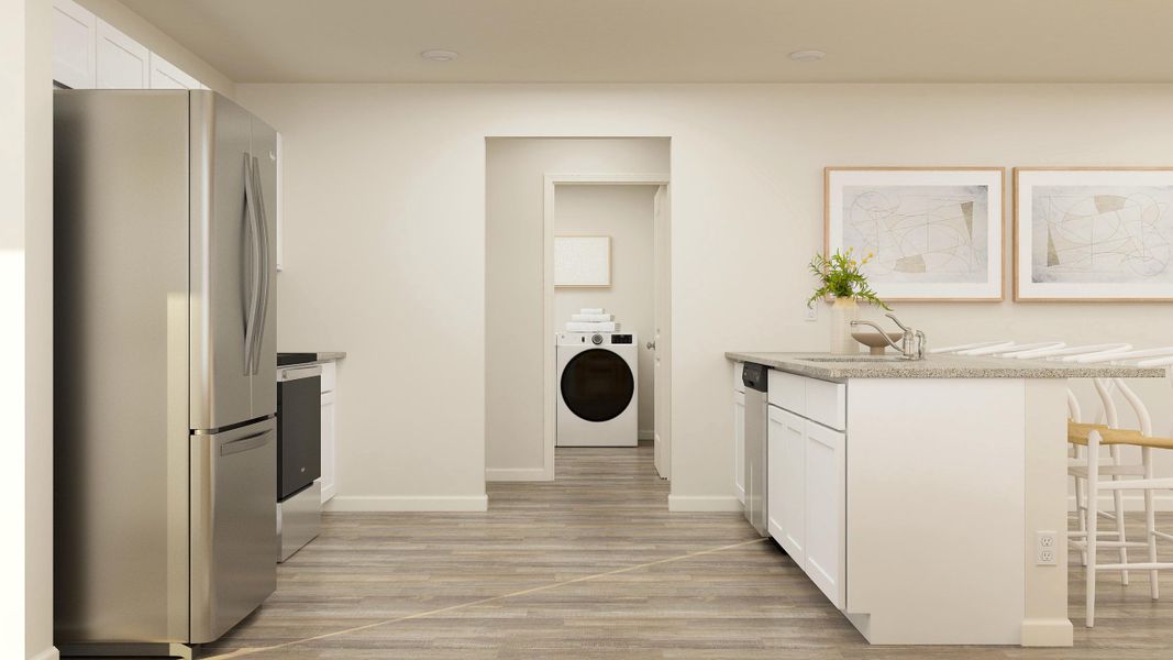 A kitchen with white cabinets.