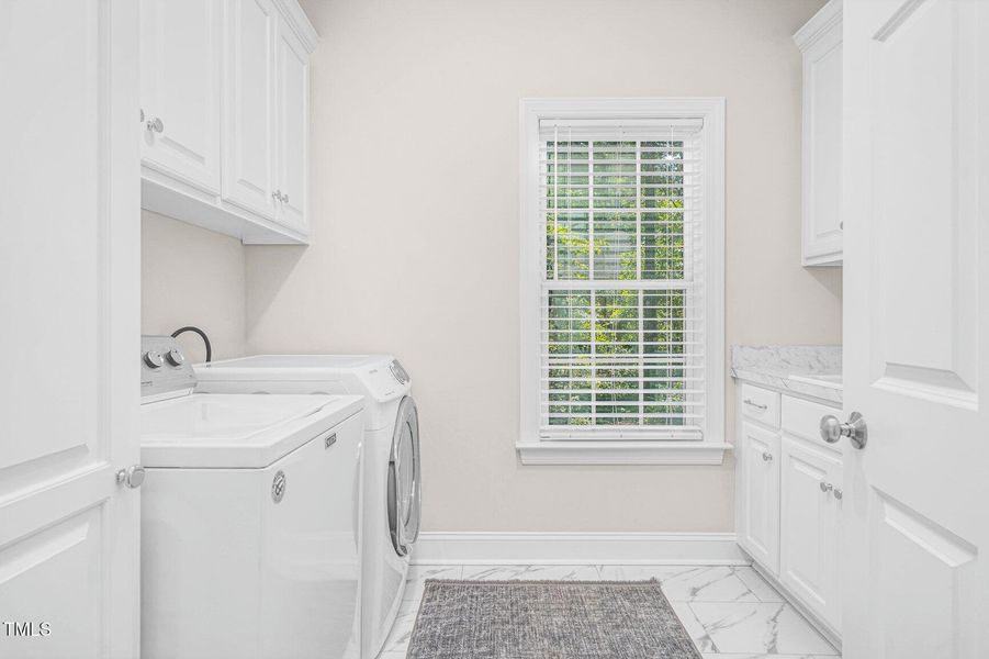 Lovely Laundry Room has sink...
