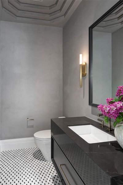 Formal powder room offers subtle drama with Segreto waxed plaster, exquisite flooring and sophisticated lighting.