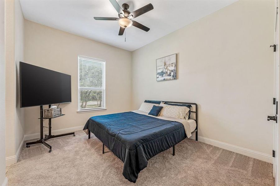 Bedroom featuring carpet floors and ceiling fan Bedroom featuring carpet floors and ceiling fan