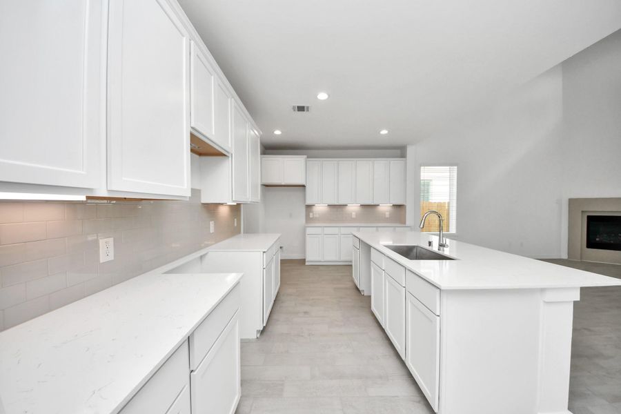 The extended counter area adds both practicality and style, making meal preparation a breeze. Every detail is thoughtfully designed to enhance the kitchen's functionality and aesthetic appeal. Sample photo of completed home with similar floor plan. Actual colors and selections may vary.