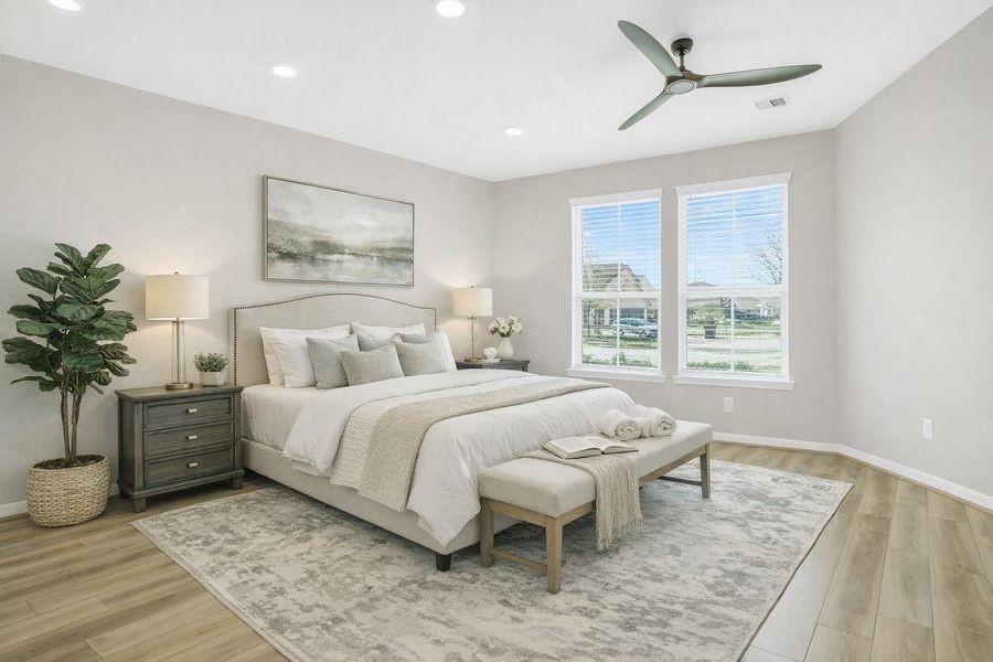 Virtually staged bedroom showcasing the room’s spacious layout, neutral palette, and abundant natural light—illustrating how comfortably the space accommodates a full bedroom setup.