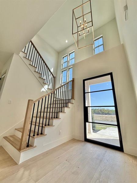 Entrance Foyer. Steel Front door, tall ceilings and handcrafted staircase with white oak treads