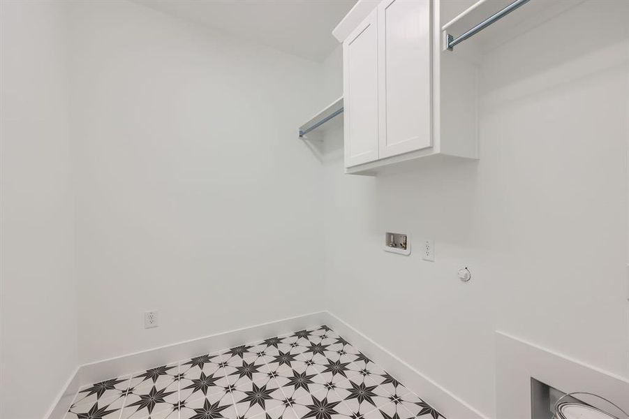 Laundry room featuring washer hookup, gas dryer hookup, and cabinets