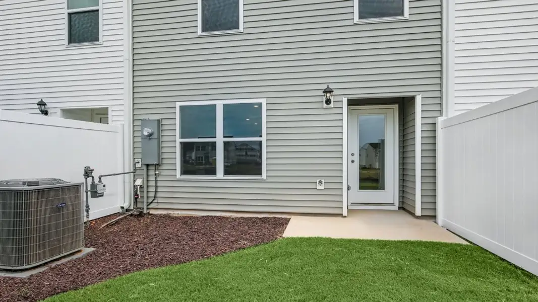 Exterior details and patio area of a home in The Townes at Hunter Hill, Rocky Mount (Image 4).