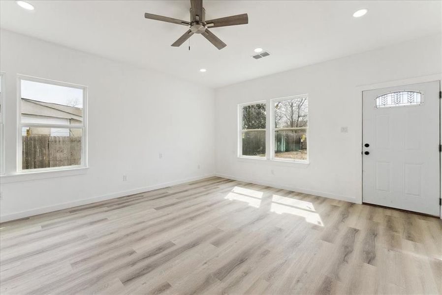 Foyer entrance featuring ceiling fan, light wood-style flooring, recessed lighting, visible vents, and baseboards