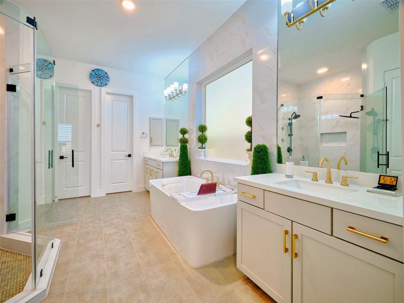 Indulge in a spa-like oasis with dual sinks, an oversized walk-in shower, and a luxurious jacuzzi tub.