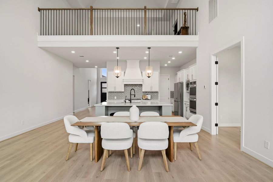 Soaring 20-foot ceilings create a dramatic sense of volume and architectural presence, while abundant natural light enhances the dining area’s open, airy feel. Generous proportions provide an impressive setting for both smaller dinners and larger gatherings, with the grand ceiling height adding elegance, warmth and a memorable sense of occasion.