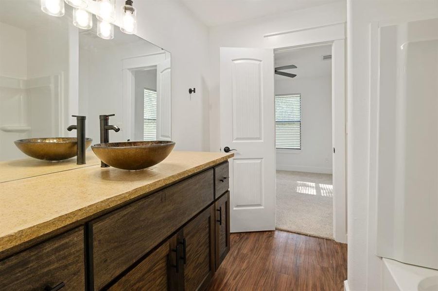 Bathroom featuring ceiling fan, vanity, and hardwood / wood-style floors